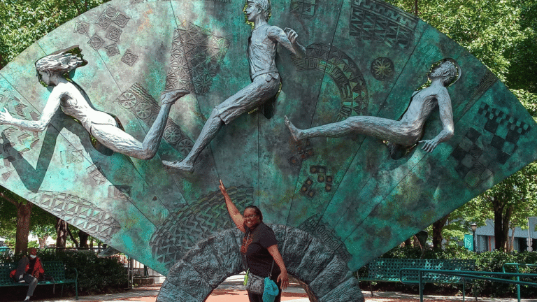 picture of christine leaning against a statue in an Atlanta park